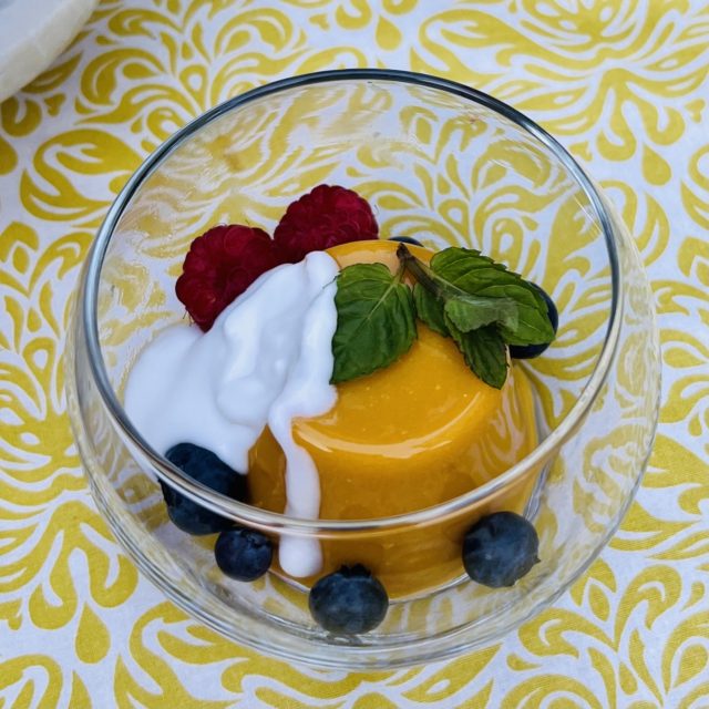 Mango pudding with coconut sauce and berries